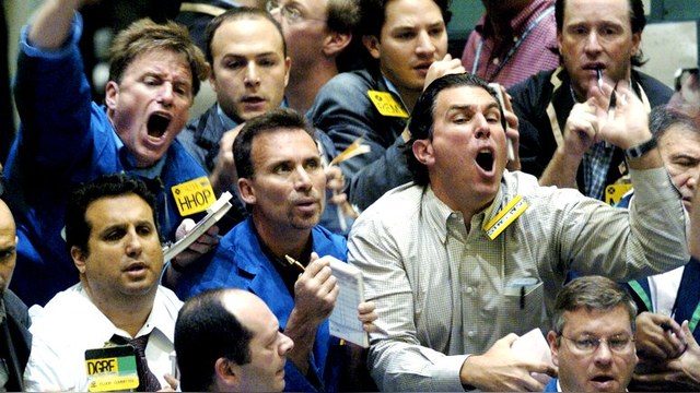 Buyers and sellers shout orders across a trading pit at the New York Mercantile Exchange early in the trading day, October 6, 2004 in New York. Oil prices neared $52 for U.S. crude, fueled by the impact of Hurricane Ivan on U.S. winter inventories. Oil has surged more than 55 percent since the start of the year, driven by the strongest demand growth in a generation and a thinning cushion of spare production capacity to cope with supply outages. REUTERS/Henny Ray Abrams  HRA - RTRCOT8